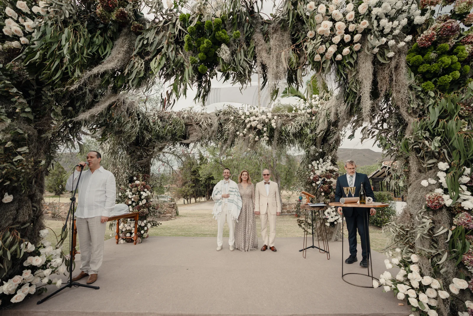 Flower chuppah surrounded by guests